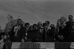 Ace Alagna, Peter Rodino and others listen to speeches on the dais during the 1973 Columbus Day Parade