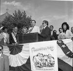 Governor Thomas Kean speaks as Frankie Avalon, Ace Alagna and others listen at the 1984 Columbus Day Parade