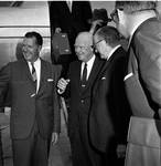 Dwight D. Eisenhower and others descend from a plane