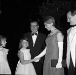 Governor Richard Hughes smiles as Princess Christina of Sweden shakes hands with a young girl