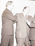 Buddy Rogers play fighting with two men