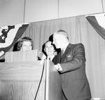 George Murphy standing at podium on stage