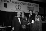 Lou Duva holding an award on stage with Donald Trump during Italian Sports Hall of Fame at the Sheraton Meadowlands