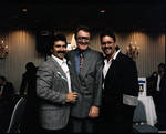 Pat Cooper standing with two men at an event