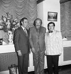 Mitch Miller standing with two men