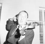 Henny Youngman playing violin behind his head