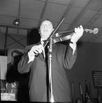 Henny Youngman on stage playing violin