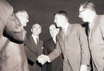 Peter W. Rodino and Richard Hughes watch as astronaut Wally Schirra shakes hands