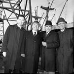 Peter W. Rodino poses with others in front of a ship