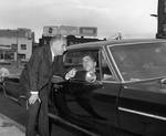 Peter W. Rodino talks to a man in a car