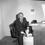 Peter W. Rodino files papers at his desk