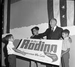 Peter W. Rodino with children holding a Re-elect Rodino, congressman who cares campaign poster