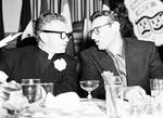 Frankie Laine at table talking to a man
