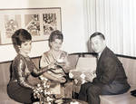 Connie Francis with group on couch showing off a tea set