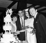 Eydie Gorme and Steve Lawrence with bride and groom cutting the cake at Westwood Restaurant