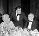 Richard Tucker at table with two fans