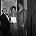 Dolly Dawn pictured with two men holding an award