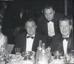 Ace Alagna poses behind Gene Kelly at dinner