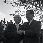 Governor Richard Hughes shakes hands during a visit to Liberty Island for signing of the 1965 Immigration Bill
