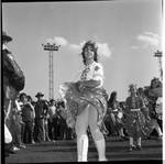 A dancer twirls her skirt at the 1971 Columbus Day Parade Stadium Gala by Ace (Armando) Alagna, 1925-2000