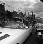 Grand Marshall Tommy LaSorda and Ace Alagna wave from the car in the 1989 Columbus Day Parade by Ace (Armando) Alagna, 1925-2000