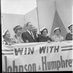 Vice President Hubert Humphrey and others pose with a Win with Johnson & Humprehy banner during 1966 tour of New Jersey by Ace (Armando) Alagna, 1925-2000