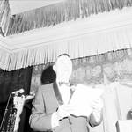 Lee Bowman standing giving a speech by Ace (Armando) Alagna, 1925-2000