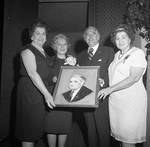 Ann Rodino, Peter W. Rodino and others hold a portrait at an event for Peter W. Rodino at Thomm's by Ace (Armando) Alagna, 1925-2000