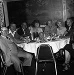 Group around dinner table Dolly Dawn performance by Ace (Armando) Alagna, 1925-2000