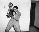 Ace Alagna poses with his camera by Ace (Armando) Alagna, 1925-2000