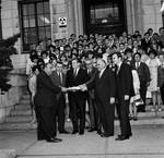 NJ State Assemblyman Ralph Caputo and other NJ Assemblymen pose with a document in front of a crowd by Ace (Armando) Alagna, 1925-2000