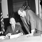 NJ Governor William T. Cahill signs a document as Attorney General Kugler looks on by Ace (Armando) Alagna, 1925-2000