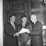 NJ State Assembly member Joseph Enos receives a document by Ace (Armando) Alagna, 1925-2000