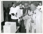 Blessing of Cornerstone for the Humanities building. The group includes Archbishop Thomas Boland, Bishop John J. Daugherty, Fr. Albert Hakim, and Msgr. Thomas G. Fahy with others standing and looking on.