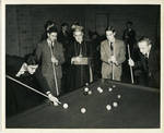 Archbishop Walsh supervising billiard players at Walsh Gym